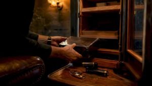 Hands placing limited-edition cigar box in humidor