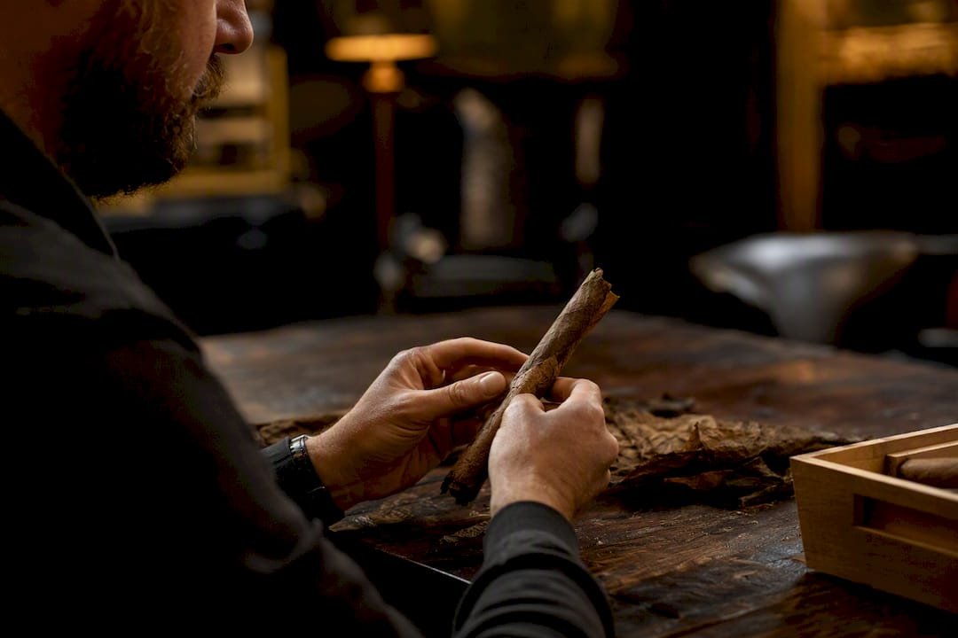 Person rolling cigar under bright light