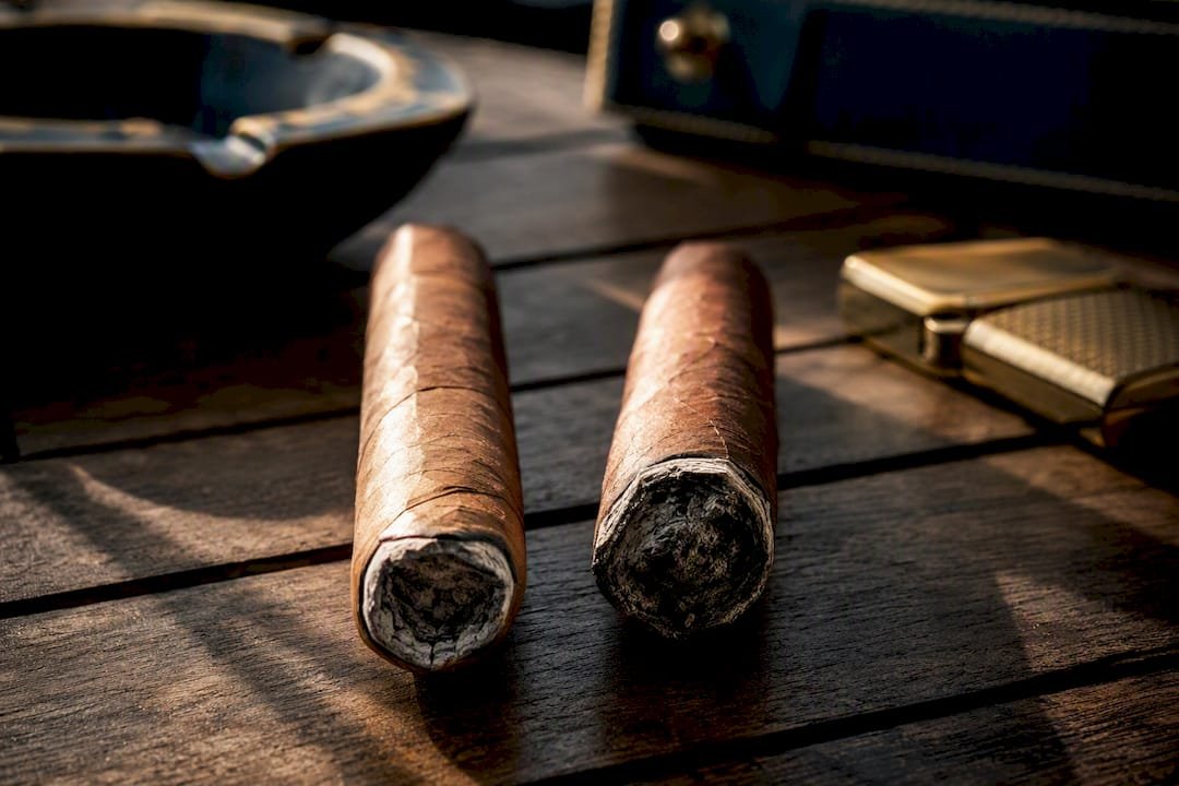 Two cigars showing small and large canoe burns
