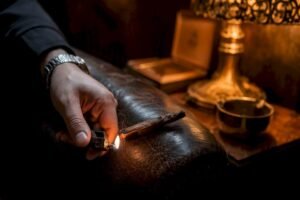 Hand touching up canoeing cigar burn with lighter