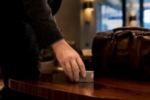 Hand placing cigar lighter in airport security tray
