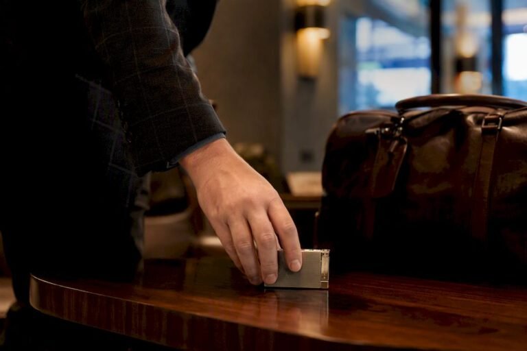 Hand placing cigar lighter in airport security tray