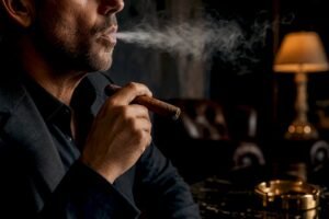 Smoker exhaling cigar smoke without inhaling