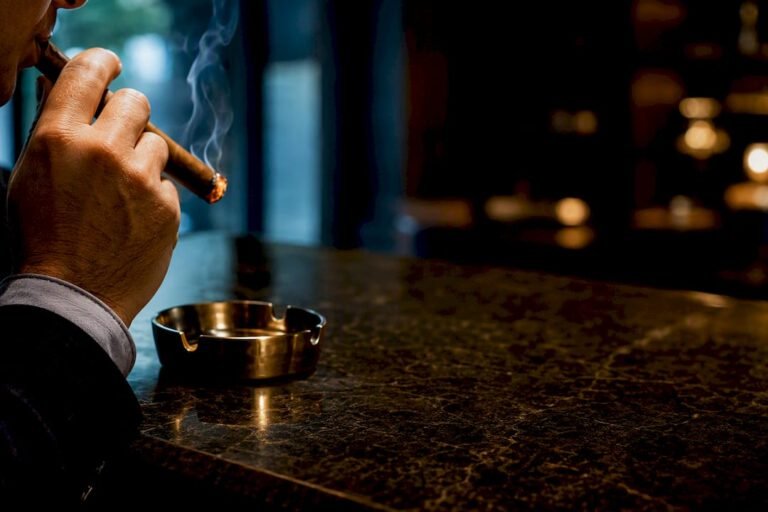 Smoker taking a slow controlled cigar draw